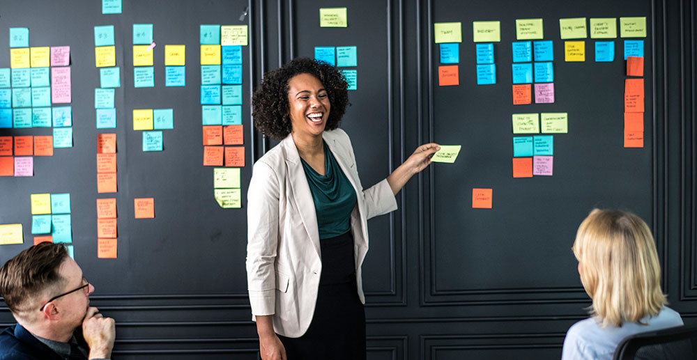 Female business founder using sticky notes