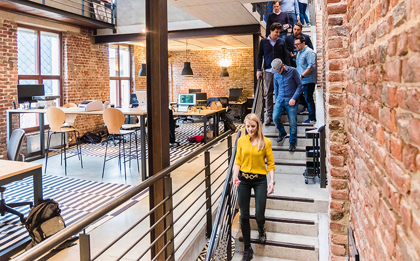 People walking down stairs of an office 