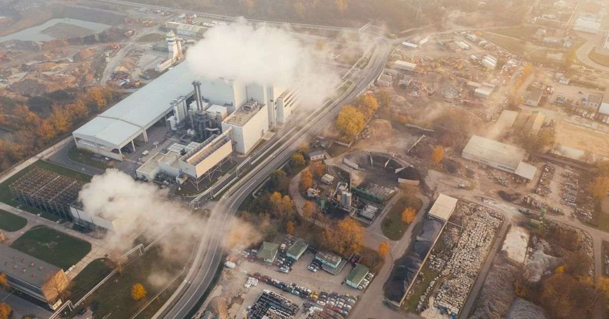 aerial shot of factory fumes and park