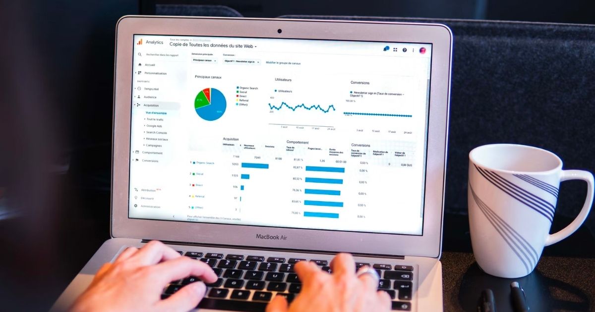 person using a laptop viewing graphs and data