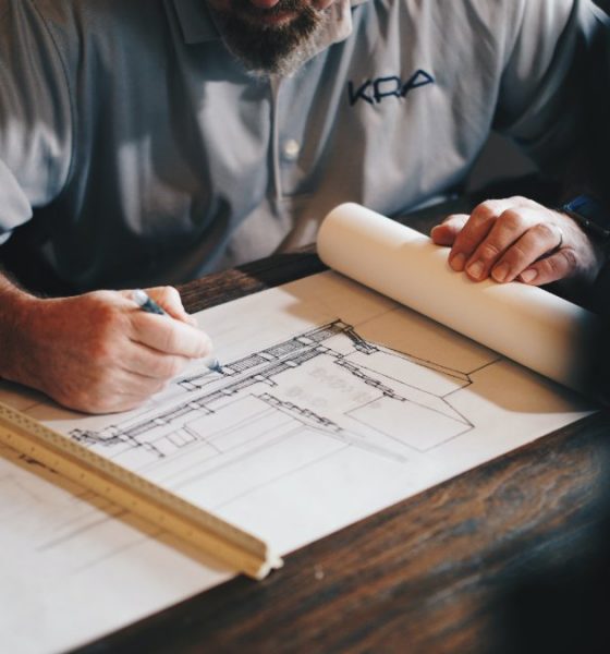 architect drawing a draft on paper