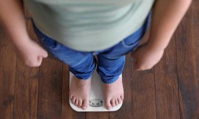man weighing themselves on a weighing scale