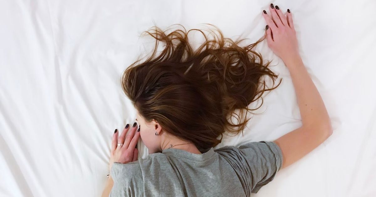 woman lying down on the bed