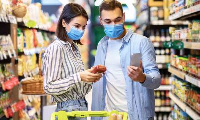 two people wearing a mask while in the grocery