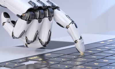 robot hand touching a keyboard