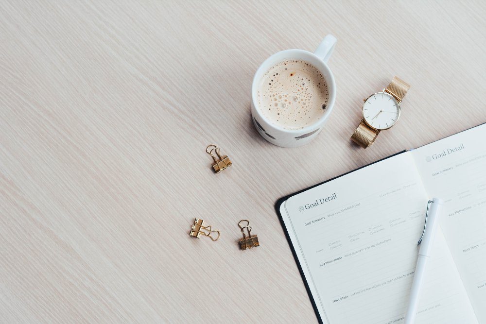 journal and coffee cup