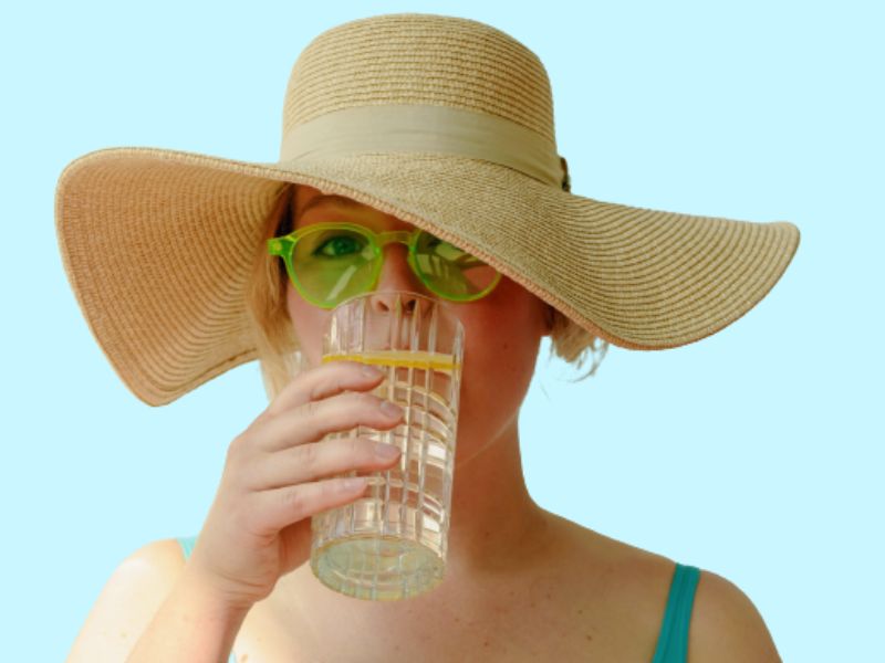 person drinking from a glass