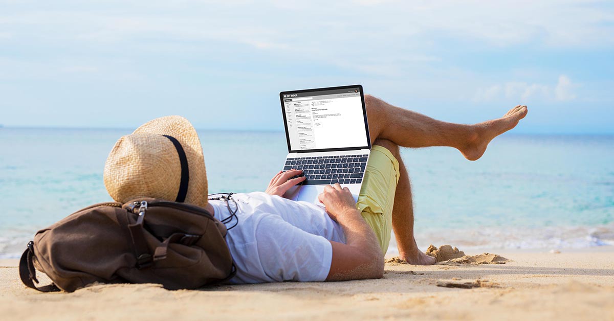 person using a laptop at the beach