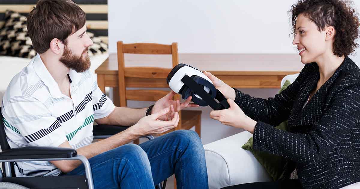 person handing another person a vr headset