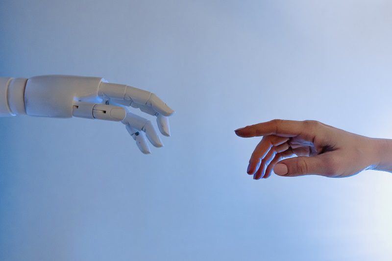 robot and human hand reaching out