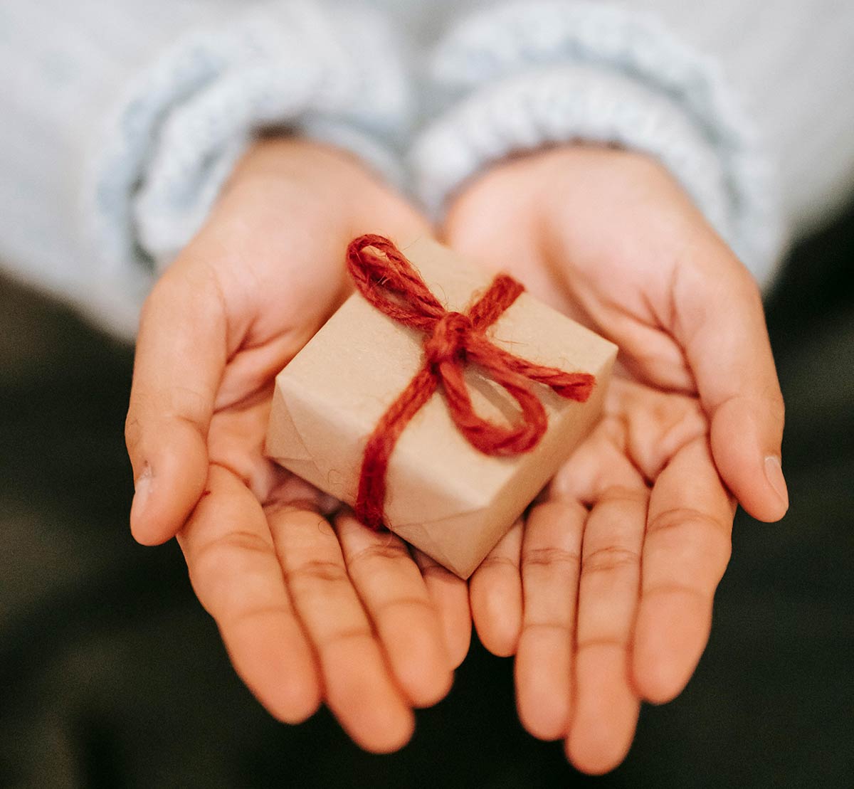 a woman's hands holding a gift