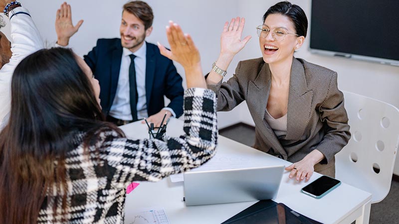 two people high fiving each other