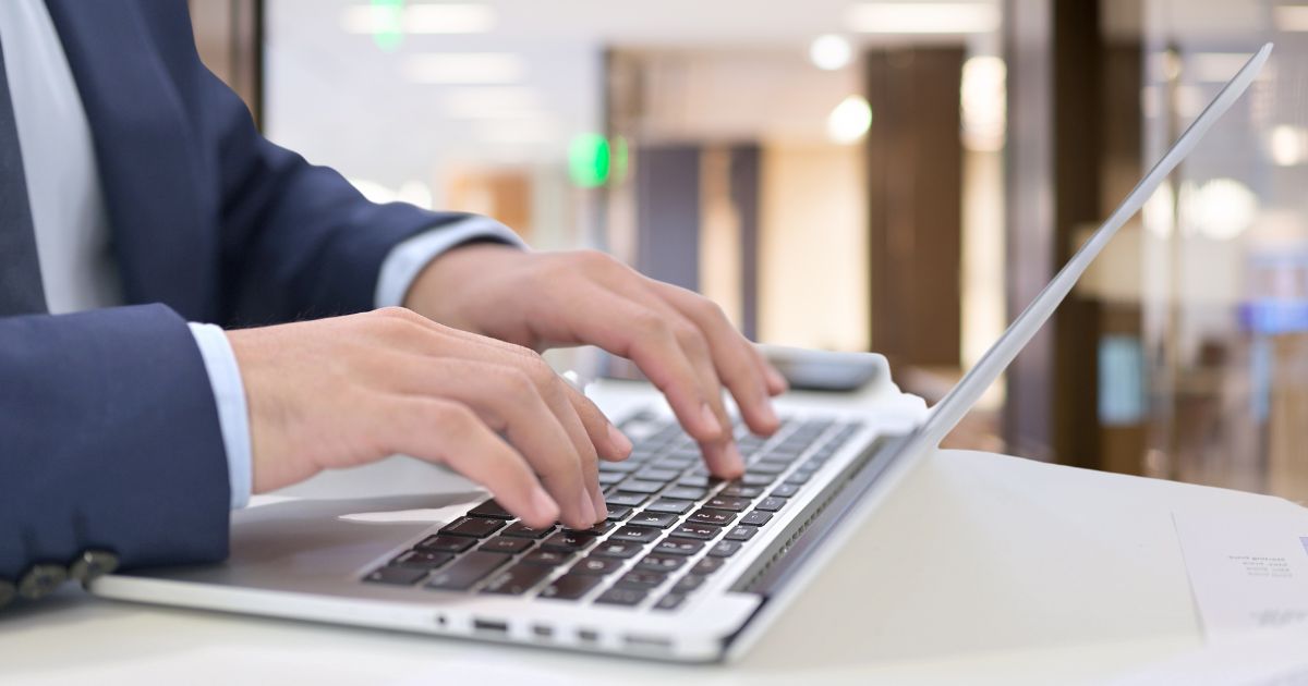 person typing on a laptop