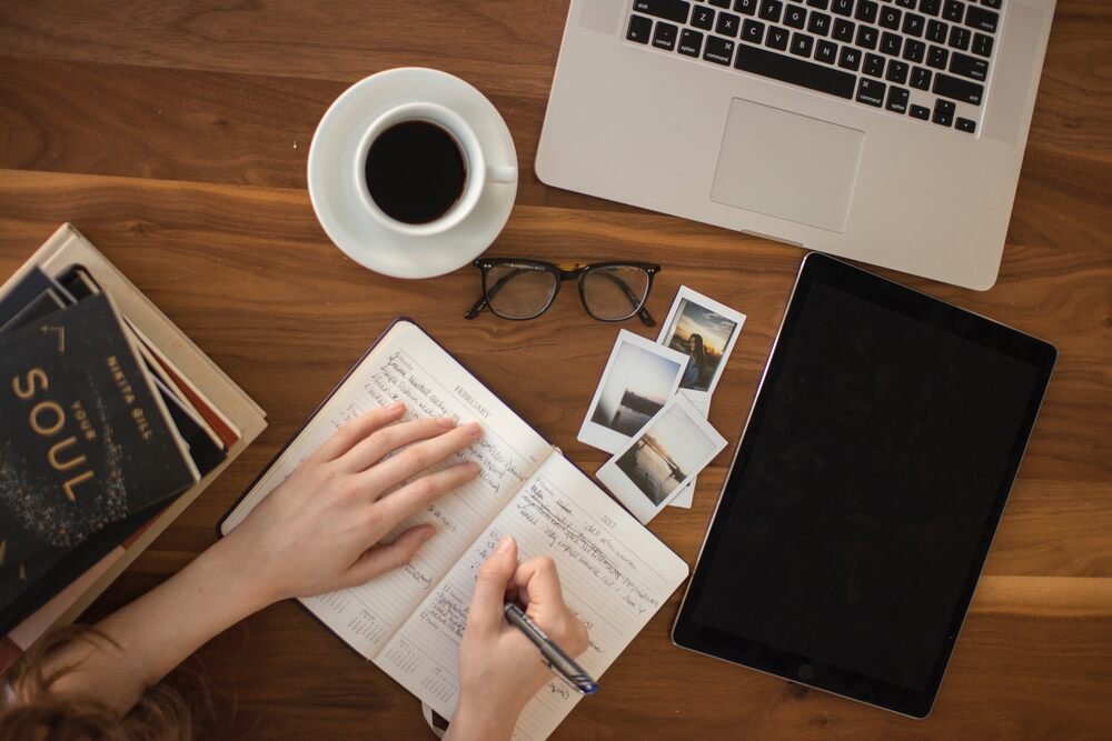 ABCD inscription and word in a notebook near a cup of coffee Stock Photo