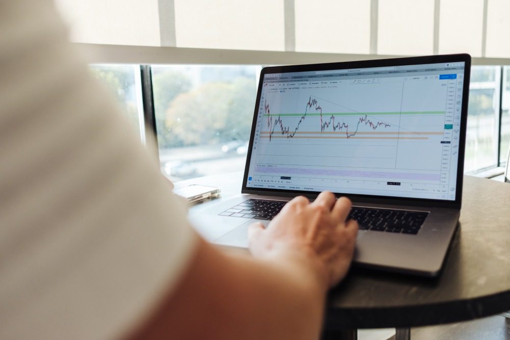 person trading stocks on a computer