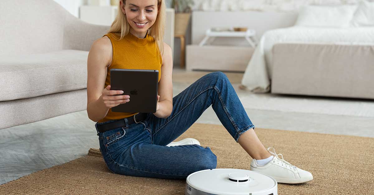 woman using a robot vacuum