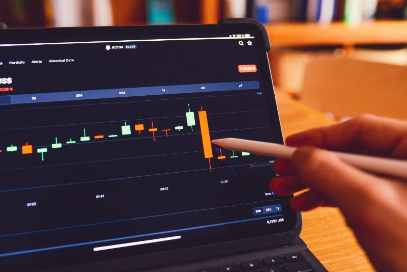 A tablet pen pointing at a steep drop on a chart