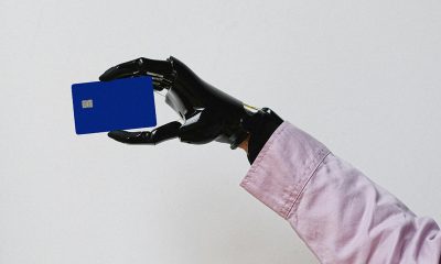 robot hand holding a card