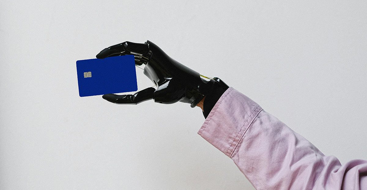 robot hand holding a card